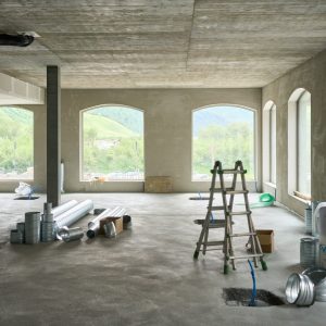 A large room with windows and a ladder